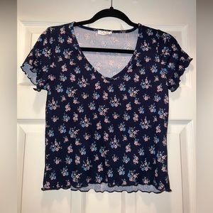 Navy blue tee with pink and blue flowers.